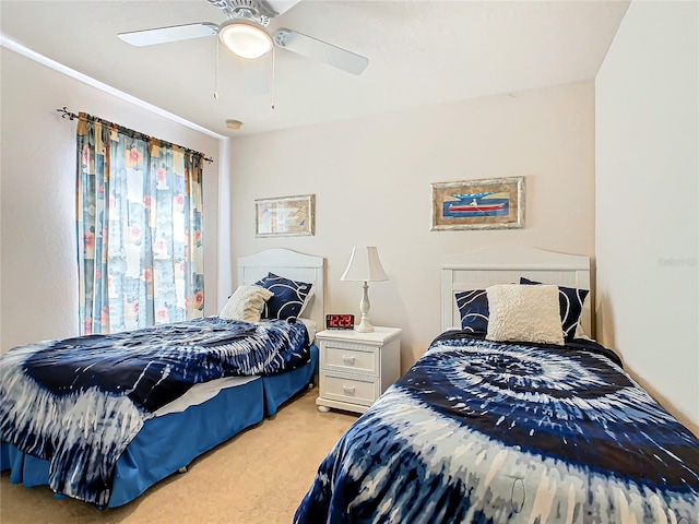 bedroom featuring ceiling fan and light carpet