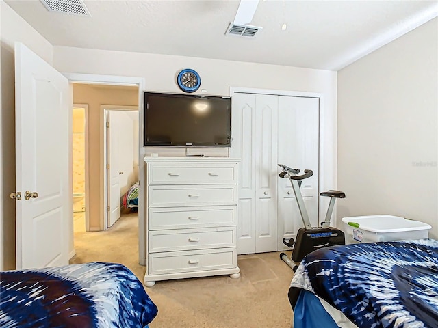 bedroom with light carpet, a closet, and ceiling fan