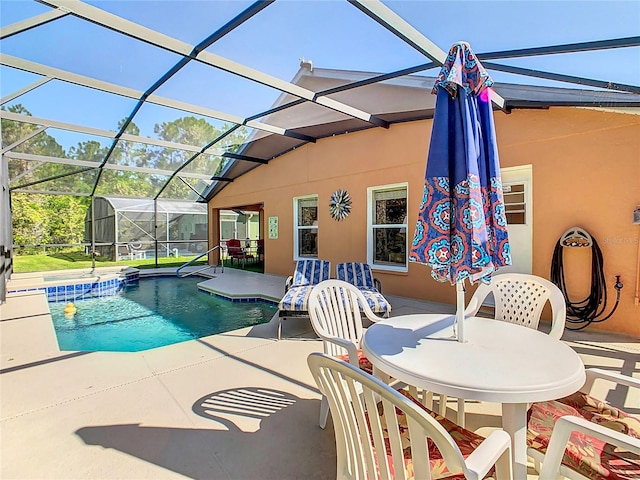 view of pool with a patio and a lanai