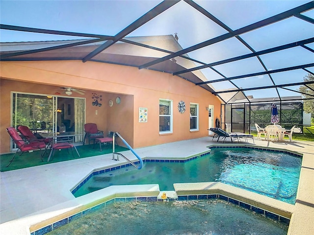 view of swimming pool with a patio, ceiling fan, an in ground hot tub, and glass enclosure