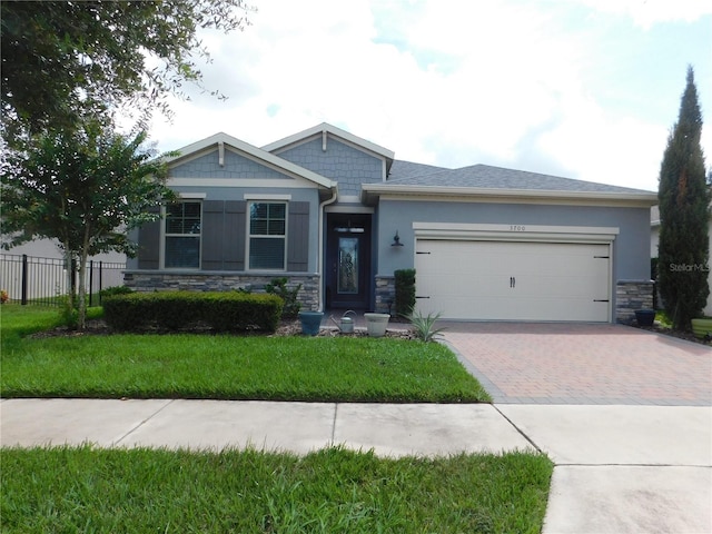 view of front of property featuring a front yard and a garage