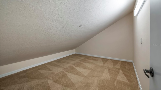 bonus room featuring carpet, a textured ceiling, and vaulted ceiling