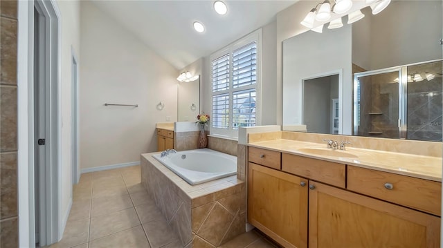 bathroom with vanity, shower with separate bathtub, lofted ceiling, and tile patterned floors