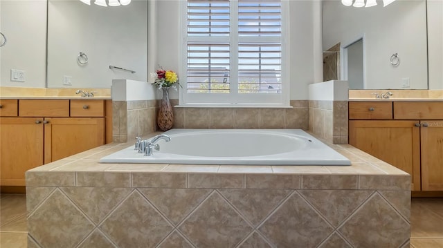 bathroom with vanity, tiled tub, and tile patterned floors