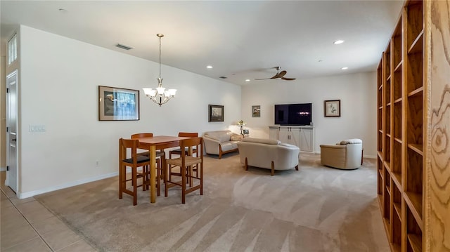 dining area with light colored carpet and ceiling fan with notable chandelier