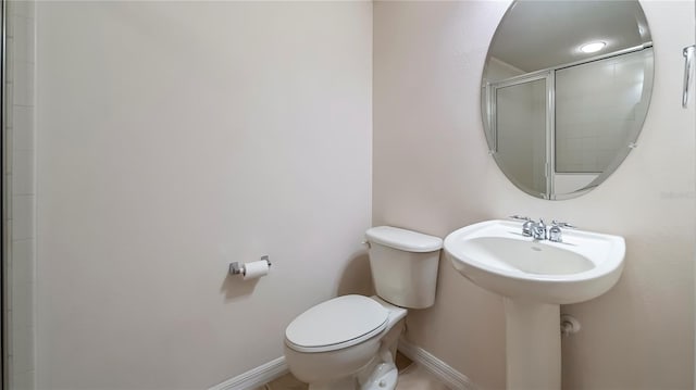 bathroom featuring toilet and walk in shower