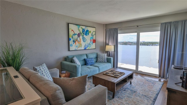 145 N Halifax Ave Unit 711, Daytona Beach, FL 32118 - living room featuring a water view and wood-type flooring