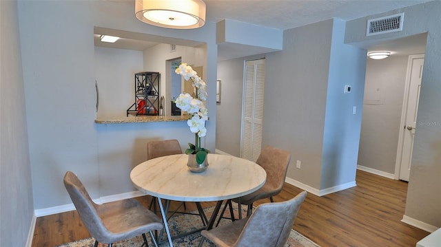 145 N Halifax Ave Unit 711, Daytona Beach, FL 32118 - dining space featuring dark wood-type flooring