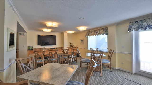 145 N Halifax Ave Unit 711, Daytona Beach, FL 32118 - dining space with a wealth of natural light, ornamental molding, carpet, and a textured ceiling