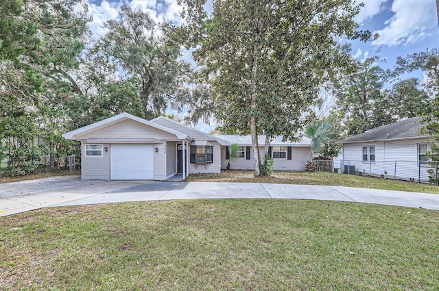 ranch-style house with a garage and a front yard