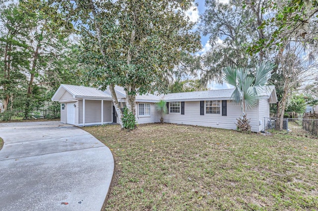 single story home with a front yard and a garage