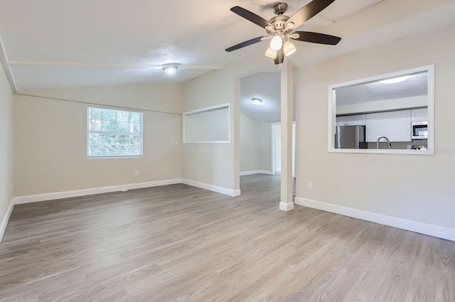 unfurnished room with ceiling fan, light hardwood / wood-style flooring, and vaulted ceiling