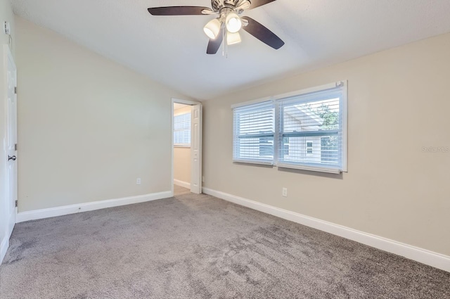 empty room with carpet flooring, ceiling fan, and vaulted ceiling