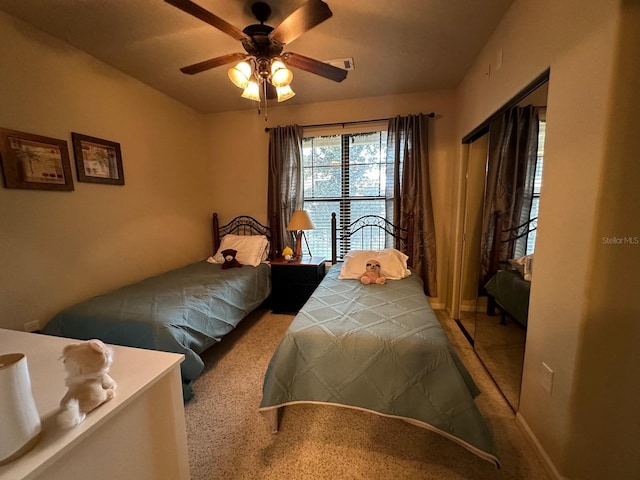 bedroom featuring light carpet and ceiling fan