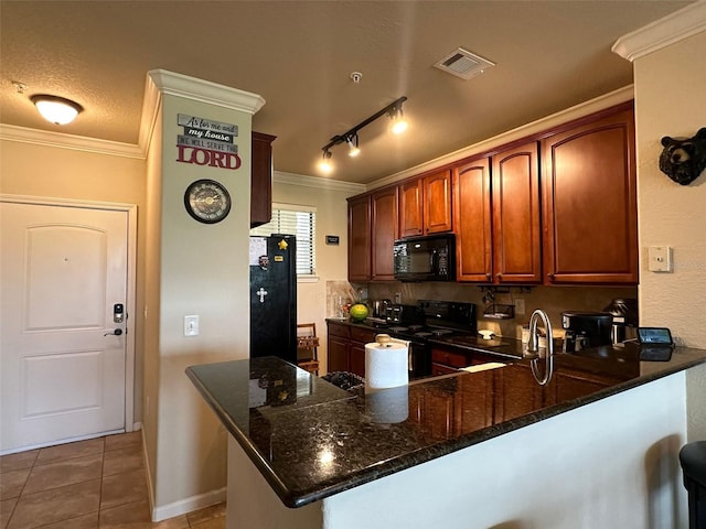 kitchen with black appliances, a textured ceiling, kitchen peninsula, tile patterned floors, and dark stone countertops