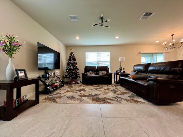 living area featuring visible vents, a notable chandelier, and recessed lighting