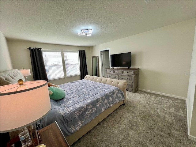 bedroom featuring light carpet, a textured ceiling, and baseboards