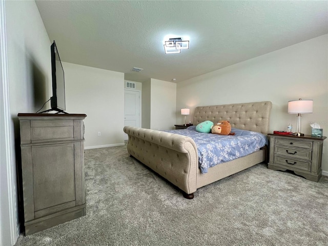 bedroom featuring carpet and a textured ceiling