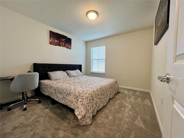 carpeted bedroom featuring a textured ceiling