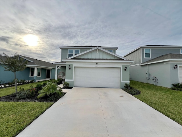 view of front facade featuring a garage, driveway, a front lawn, and board and batten siding