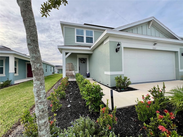 view of front facade featuring board and batten siding, a front lawn, a garage, and stucco siding