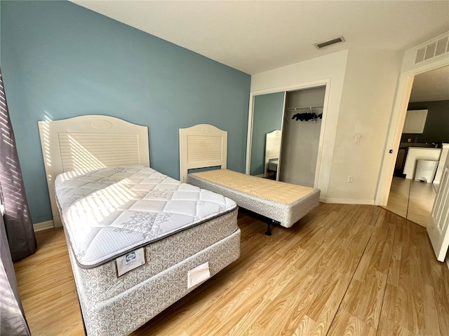 bedroom with hardwood / wood-style flooring and a closet