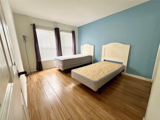 2878 Club Cortile Cir Unit A, Kissimmee, FL 34746 - bedroom featuring baseboards and wood finished floors