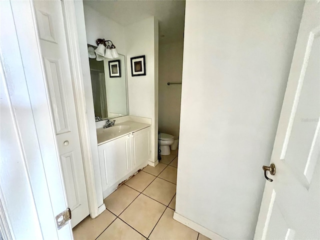 bathroom featuring vanity, tile patterned floors, and toilet