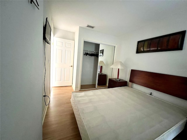 bedroom featuring hardwood / wood-style flooring and a closet