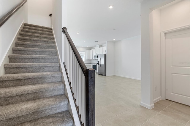 staircase featuring tile patterned flooring