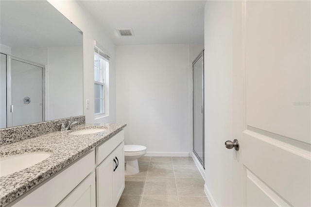 bathroom with toilet, walk in shower, vanity, and tile patterned floors