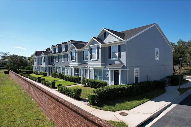 view of side of property with a lawn