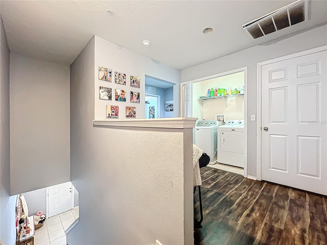 laundry room featuring separate washer and dryer and hardwood / wood-style floors