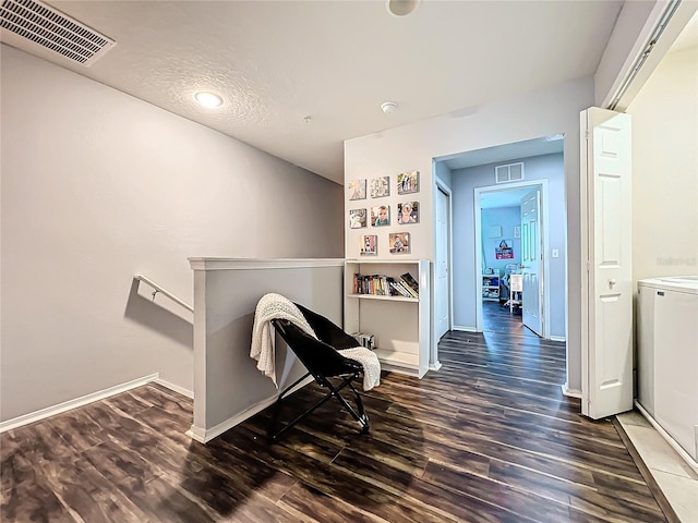 hallway featuring a textured ceiling and dark hardwood / wood-style flooring