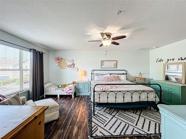 bedroom featuring a textured ceiling, ceiling fan, and dark hardwood / wood-style flooring