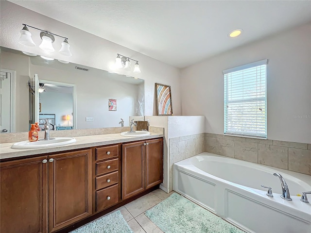 bathroom with vanity, tile patterned floors, ceiling fan, and a bathing tub