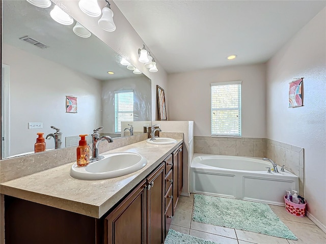 bathroom featuring a bath, tile patterned floors, a wealth of natural light, and vanity