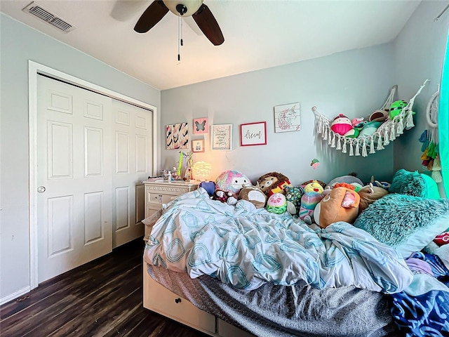 bedroom featuring a closet, dark wood-type flooring, and ceiling fan