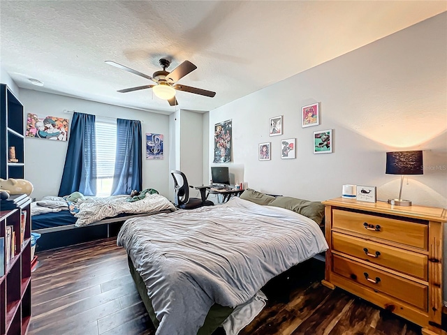 bedroom featuring a textured ceiling, dark hardwood / wood-style floors, and ceiling fan