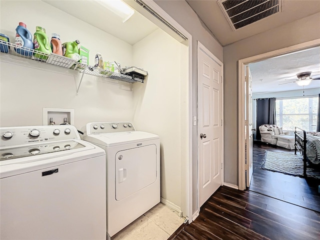 laundry room featuring dark wood-type flooring, washer and clothes dryer, and ceiling fan