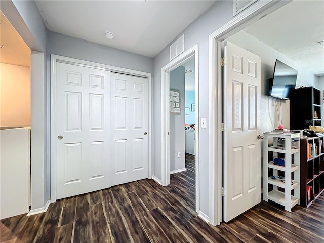 hallway featuring dark wood-type flooring