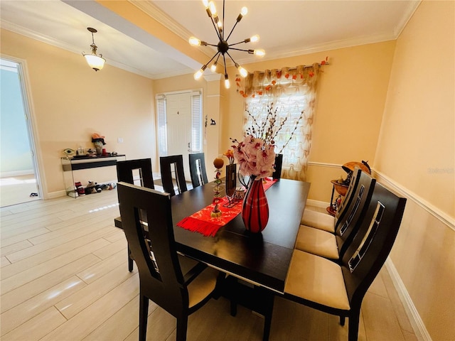 dining space with a wealth of natural light, a chandelier, light wood-type flooring, and ornamental molding