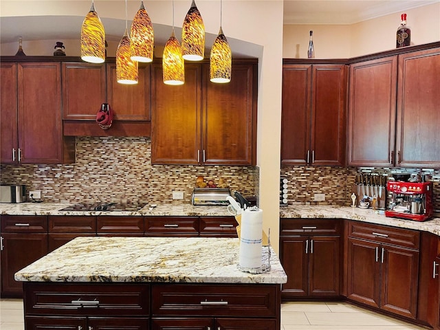 kitchen with pendant lighting, black stovetop, decorative backsplash, light tile patterned floors, and light stone counters