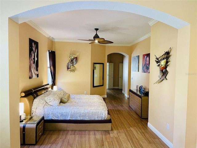 bedroom with ceiling fan, light hardwood / wood-style floors, and ornamental molding