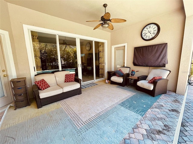 sunroom featuring ceiling fan