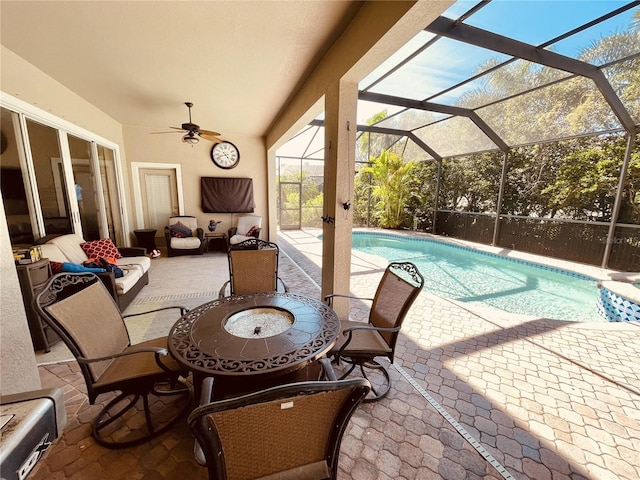 view of swimming pool featuring a lanai, ceiling fan, a patio area, and an outdoor hangout area