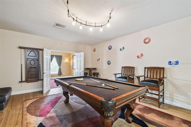 recreation room with pool table, visible vents, a textured ceiling, wood finished floors, and baseboards