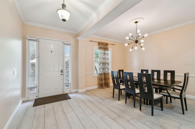 foyer featuring baseboards, wood finish floors, a notable chandelier, and crown molding