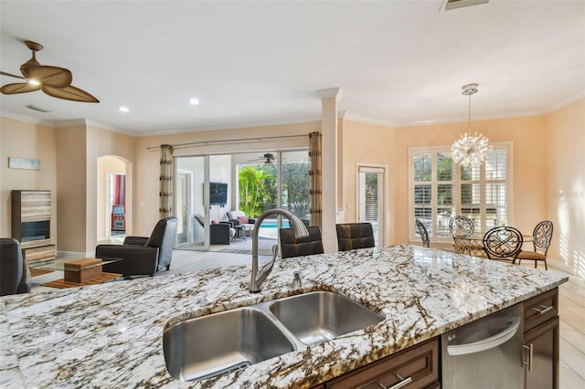 kitchen featuring ceiling fan with notable chandelier, hanging light fixtures, a sink, and visible vents