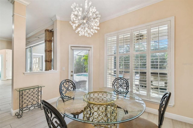 dining area with decorative columns, baseboards, ornamental molding, an inviting chandelier, and light wood-style floors